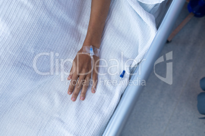 Female patient lying on bed in the ward at hospital