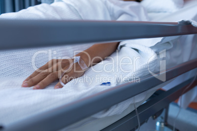 Female patient lying on bed in the ward at hospital