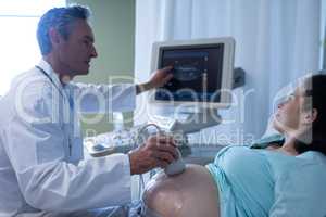 Doctor doing ultrasound scan for pregnant woman in hospital