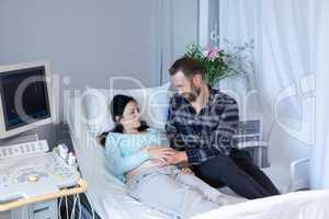 Man comforting pregnant woman in the ward