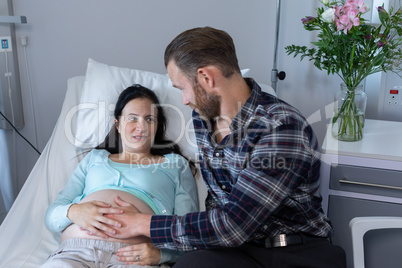 Man comforting pregnant woman in the ward