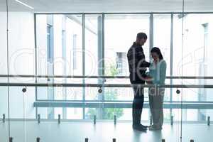 Man comforting pregnant woman in the corridor