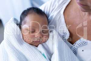 Mother holding newborn baby in hospital