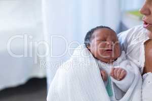 Mother consoling newborn baby in hospital