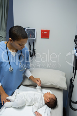 Doctor examining baby in medical examination room