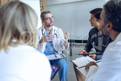 Medical team discussing with each other in hospital