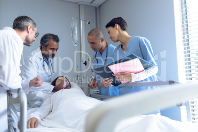 Doctor adjusting oxygen mask while patient lying in bed