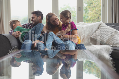 Caucasian family having fun on the sofa in a comfortable home