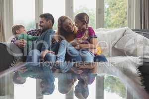 Caucasian family having fun on the sofa in a comfortable home