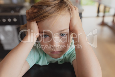 Boy with hands on head looking at camera