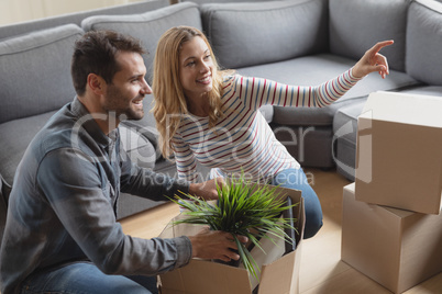 Woman showing something to man while unpacking