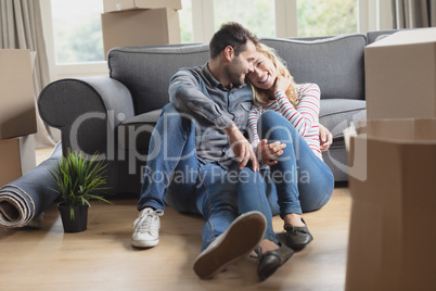 Romantic couple sitting together in new home