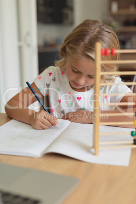 Girl study at table in comfortable home