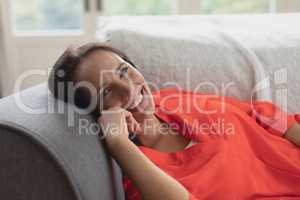 Beautiful woman relaxing on a sofa in living room at home