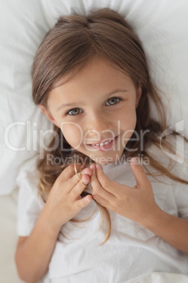 Girl relaxing in bed in bedroom at home