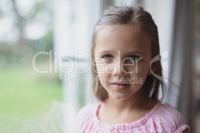 Girl looking near window at home