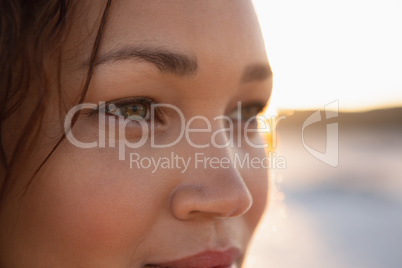 Beautiful woman looking away on the beach