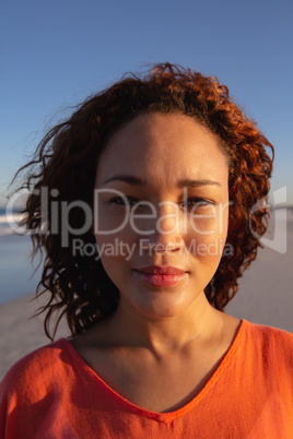 Beautiful woman looking at camera on beach in the sunshine