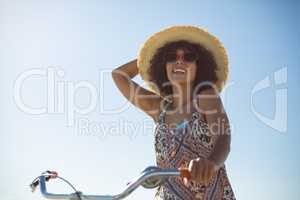 Woman with bicycle at beach on a sunny day