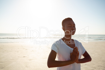 Woman performing yoga on the beach