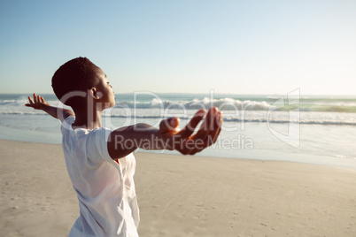 Woman performing yoga on the beach