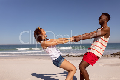 Couple having fun on beach in the sunshine