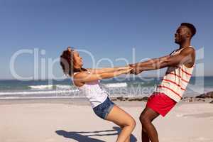 Couple having fun on beach in the sunshine