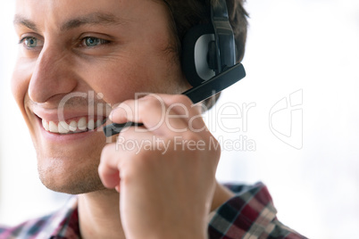 Male customer service executive talking on headset in office