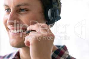 Male customer service executive talking on headset in office