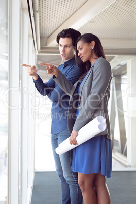 Male and female architects interacting with each other in office