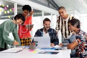 Business people discussing over laptop in the conference room