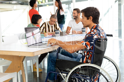 Disabled businessman using laptop in the conference room