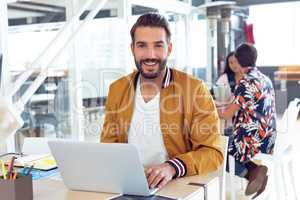 Businessman using laptop on desk in the office