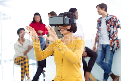 Young businesswoman using virtual reality headset in a modern office
