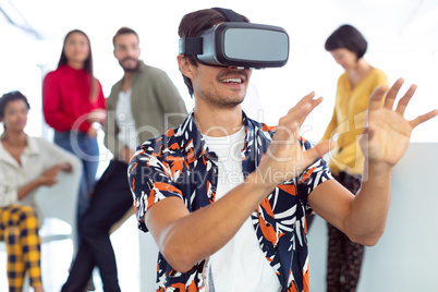 Young businessman using virtual reality headset in a modern office