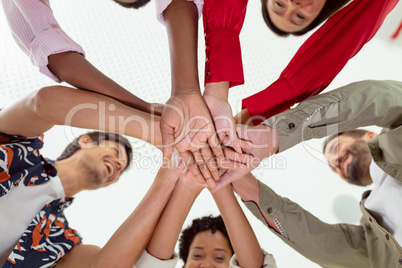 Business people forming hand stack in a modern office