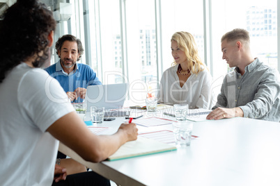 Business people discussing with each other in meeting at conference room in a modern office