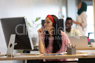 Female customer service executive talking on headset in a modern office