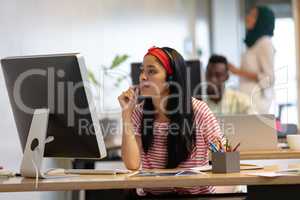 Female customer service executive talking on headset in a modern office