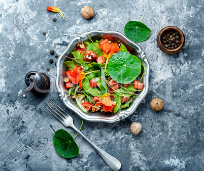 Salad with vegetables, nuts and nasturtium