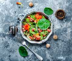 Salad with vegetables, nuts and nasturtium