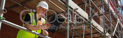 Construction Foreman Builder on Building Site Clipboard and Mug