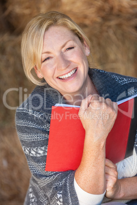 Happy Laughing Middle Aged Woman Reading a Book or Diary