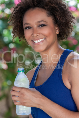 African American Biracial Woman Exercising Drinking Water Bottle