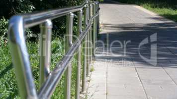 metal fence in park at dry sunny summer day