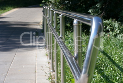 metal fence in park at dry sunny summer day