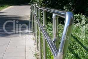 metal fence in park at dry sunny summer day