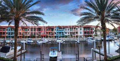 Colorful buildings and a harbor of boats along a waterway