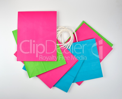 multi-colored paper shopping bags with white handles