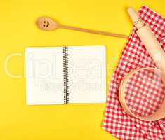 blank open notebook and wooden kitchen accessories